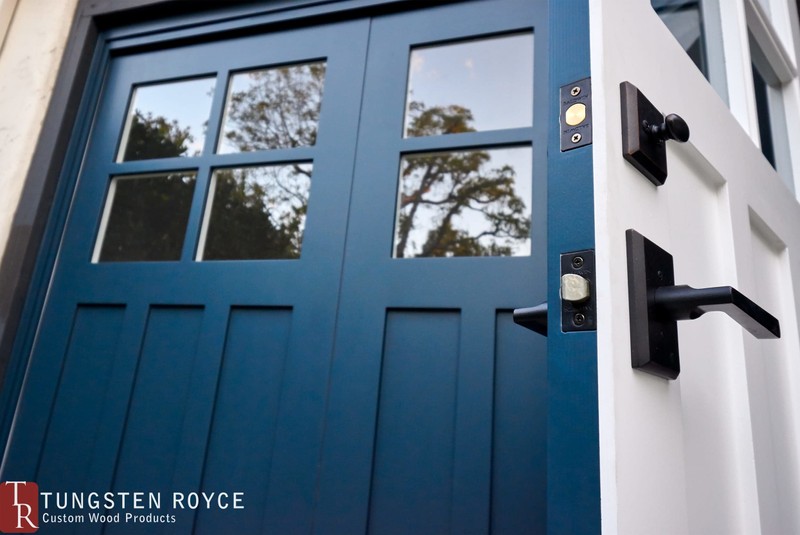 Blue carriage garage doors. Door open to show handleset.